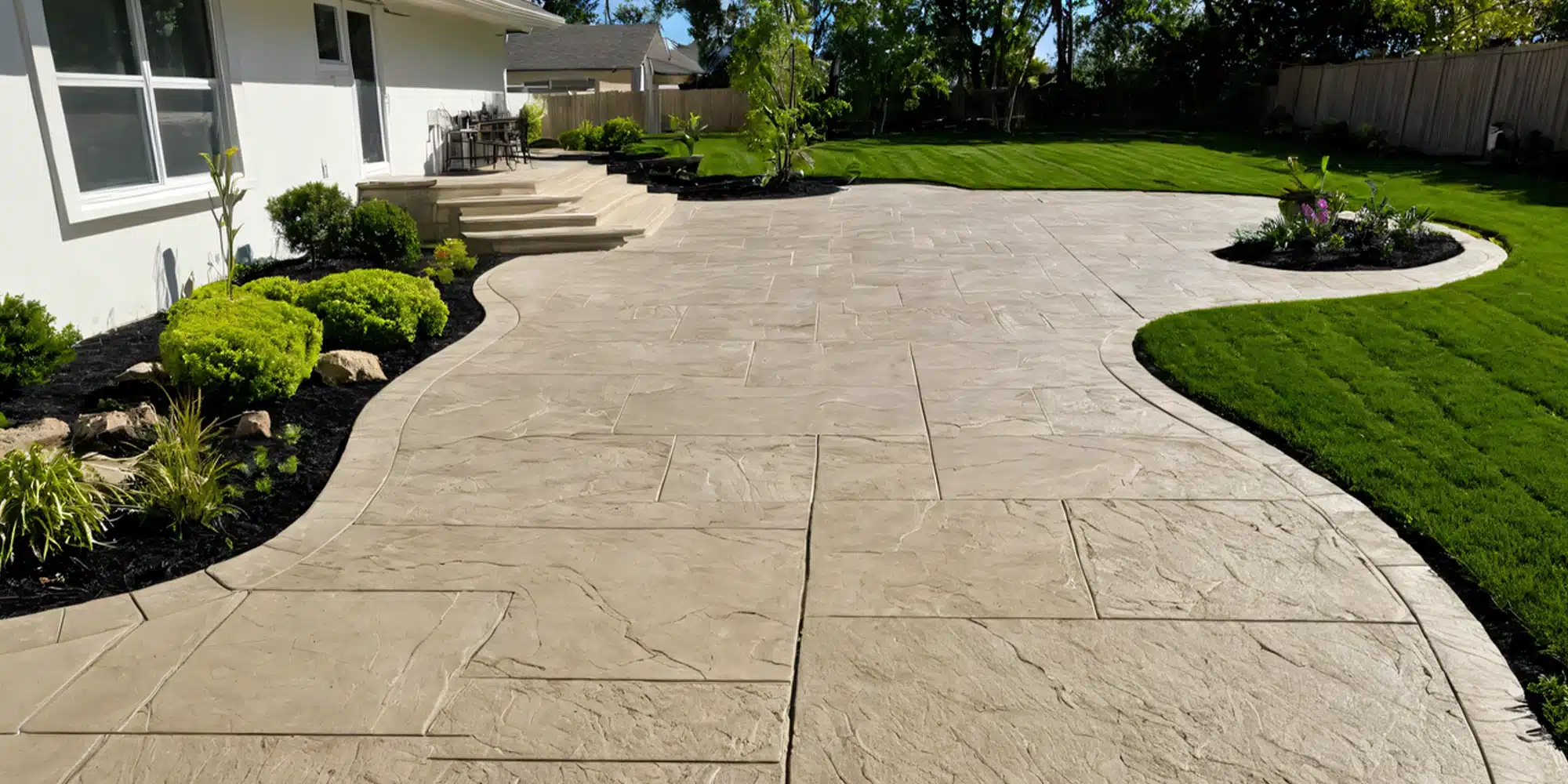 A finished stamped concrete patio and walkway by Hoffman Concrete Contractors